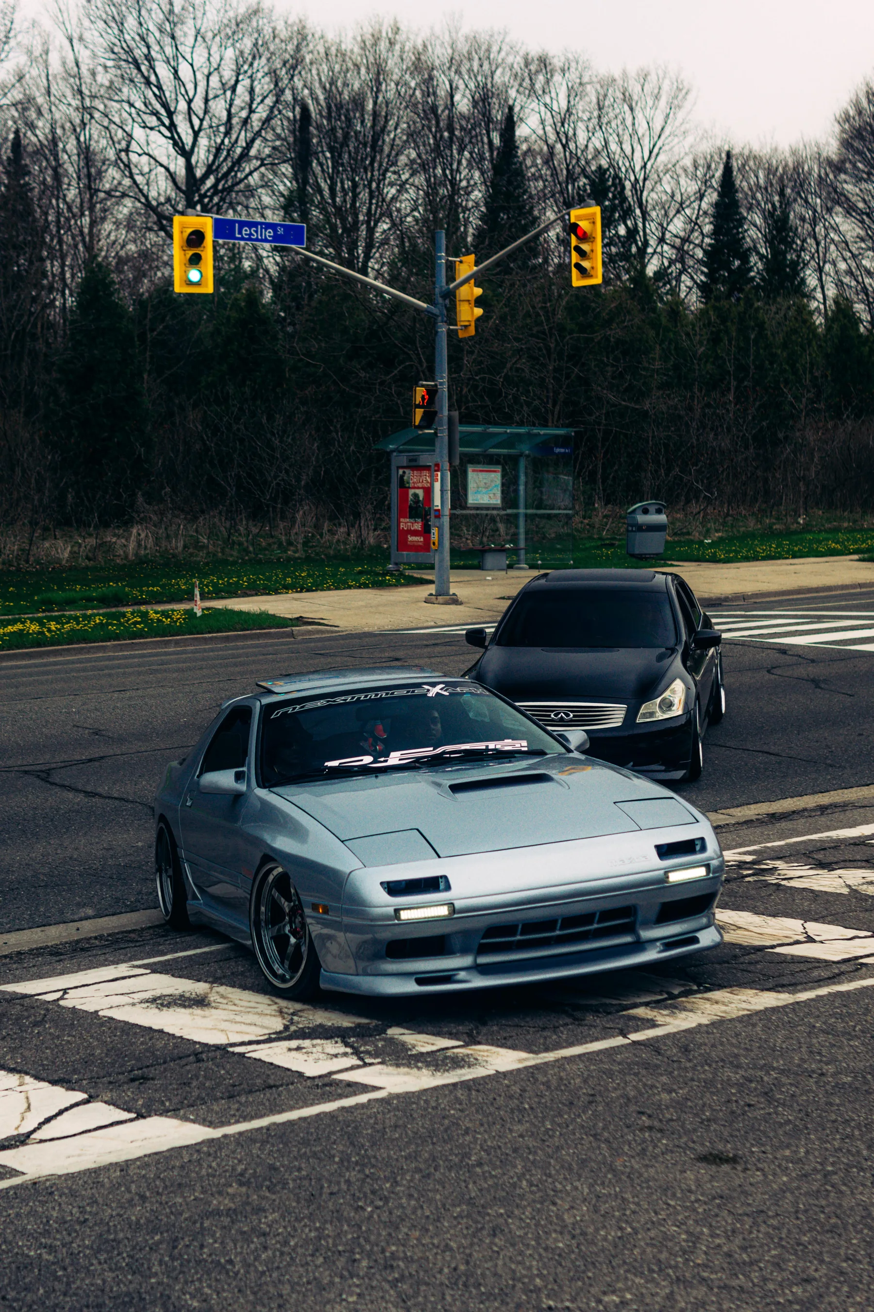 Silver Mazda RX-7 FC and black Infiniti G35 at the Leslie St intersection