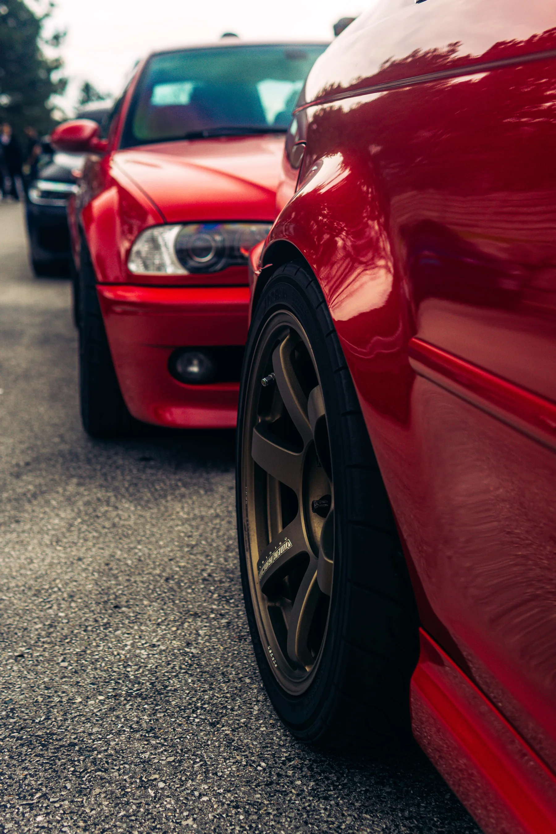 Low-angle detail of a red E46 M3 on bronze Volk forged wheels