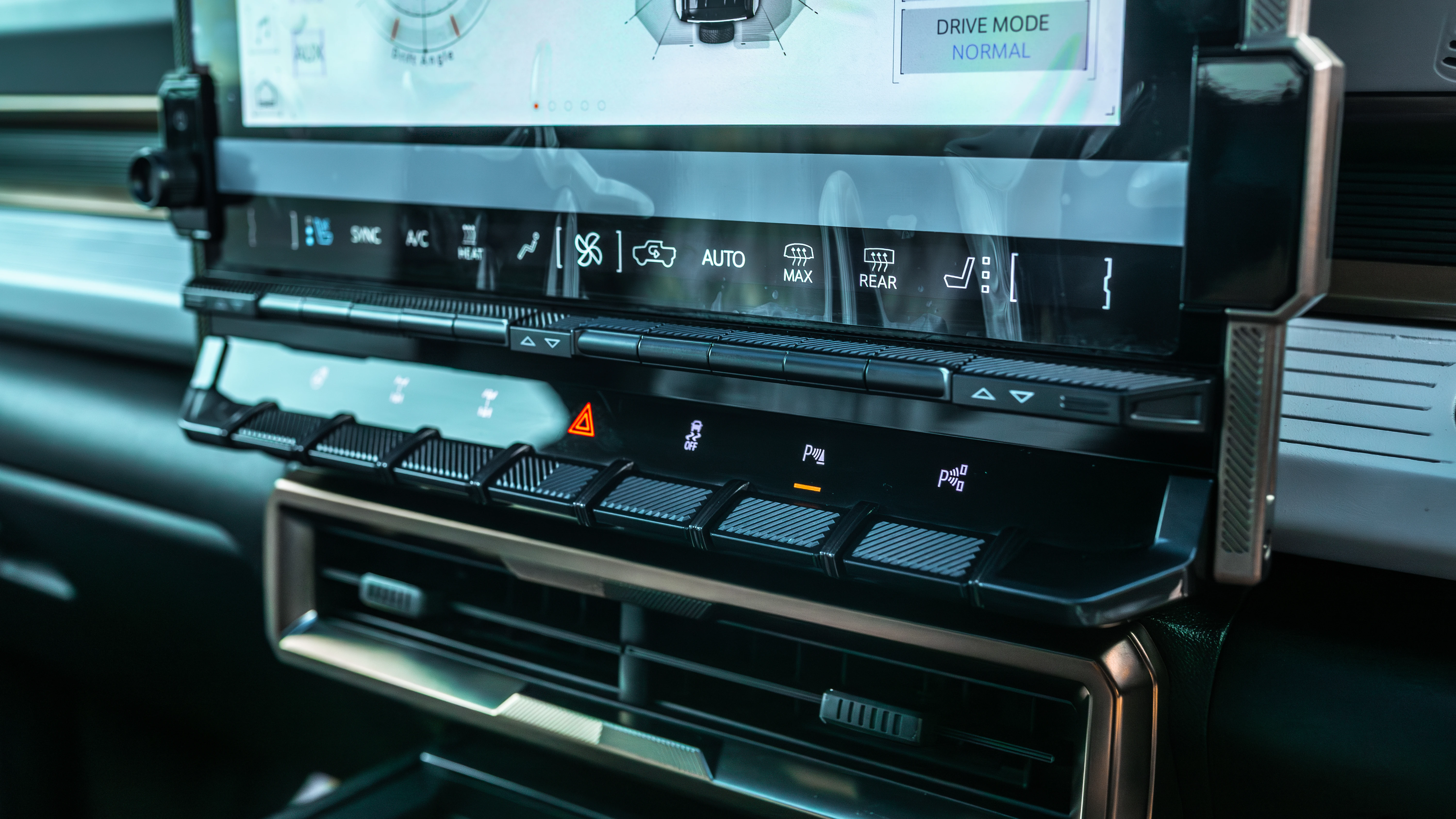 Physical climate and audio controls below the touchscreen