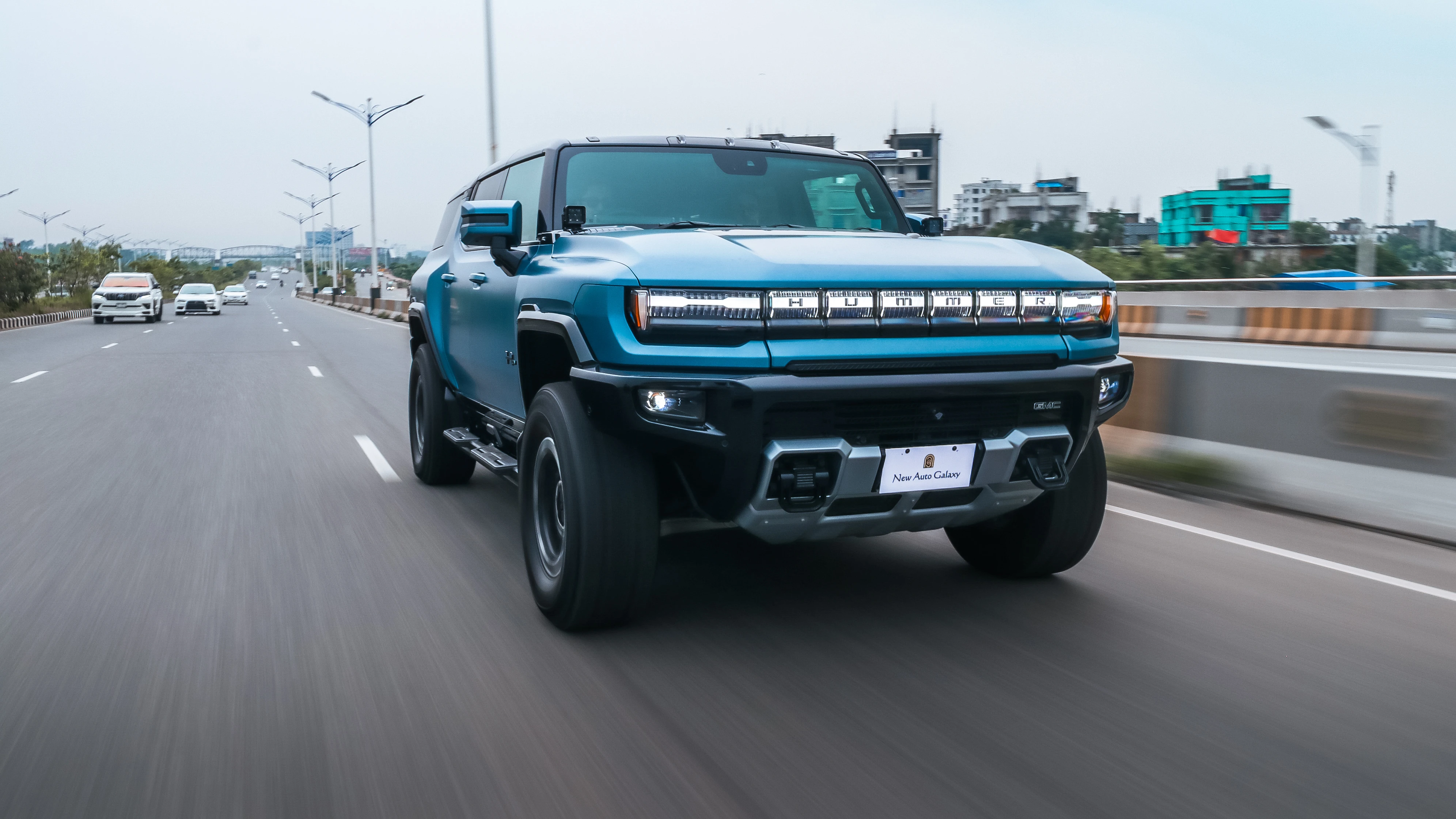 Hummer EV rolling head-on through Dhaka city traffic