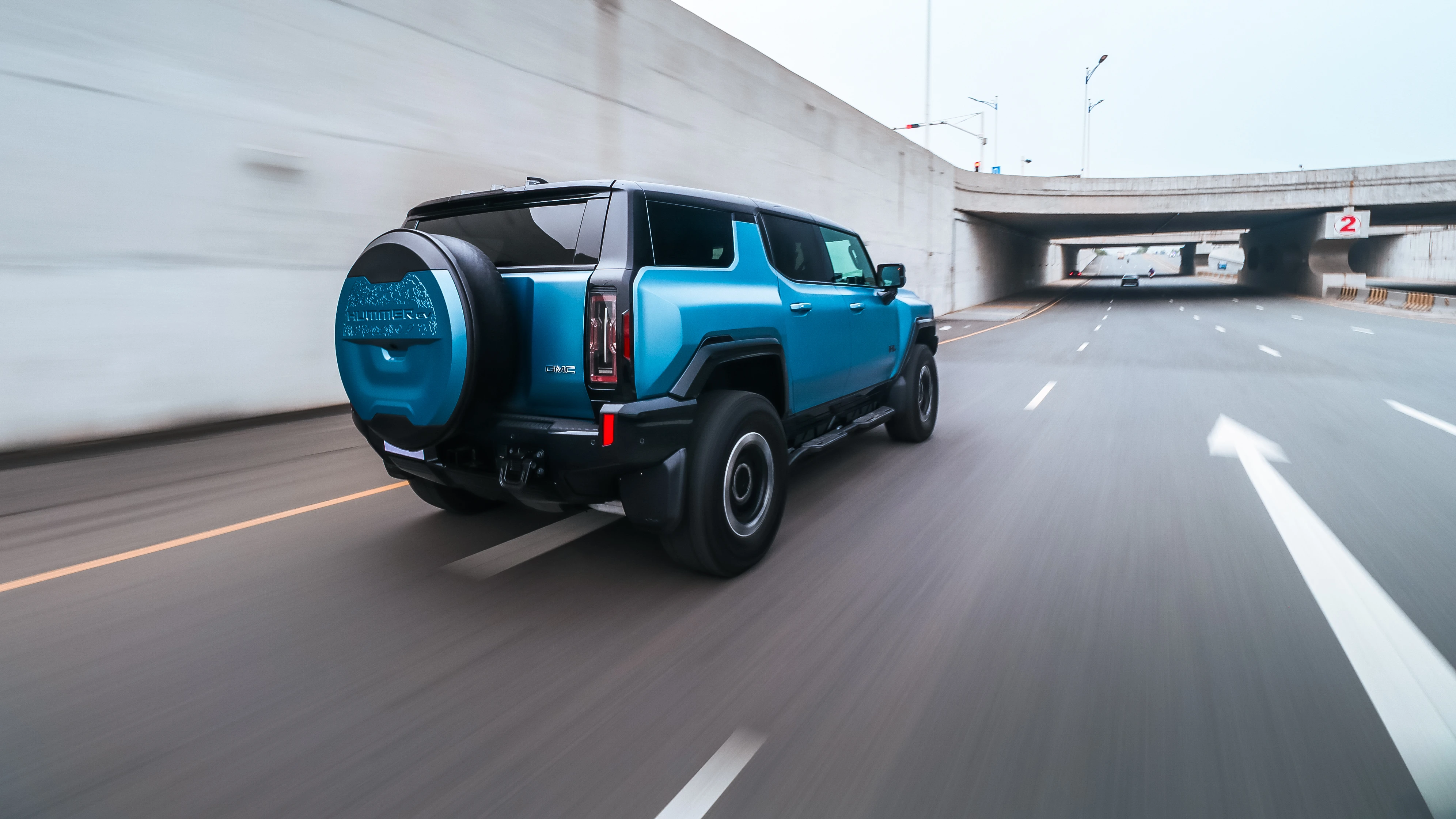 Rear view of the Hummer EV accelerating into an underpass