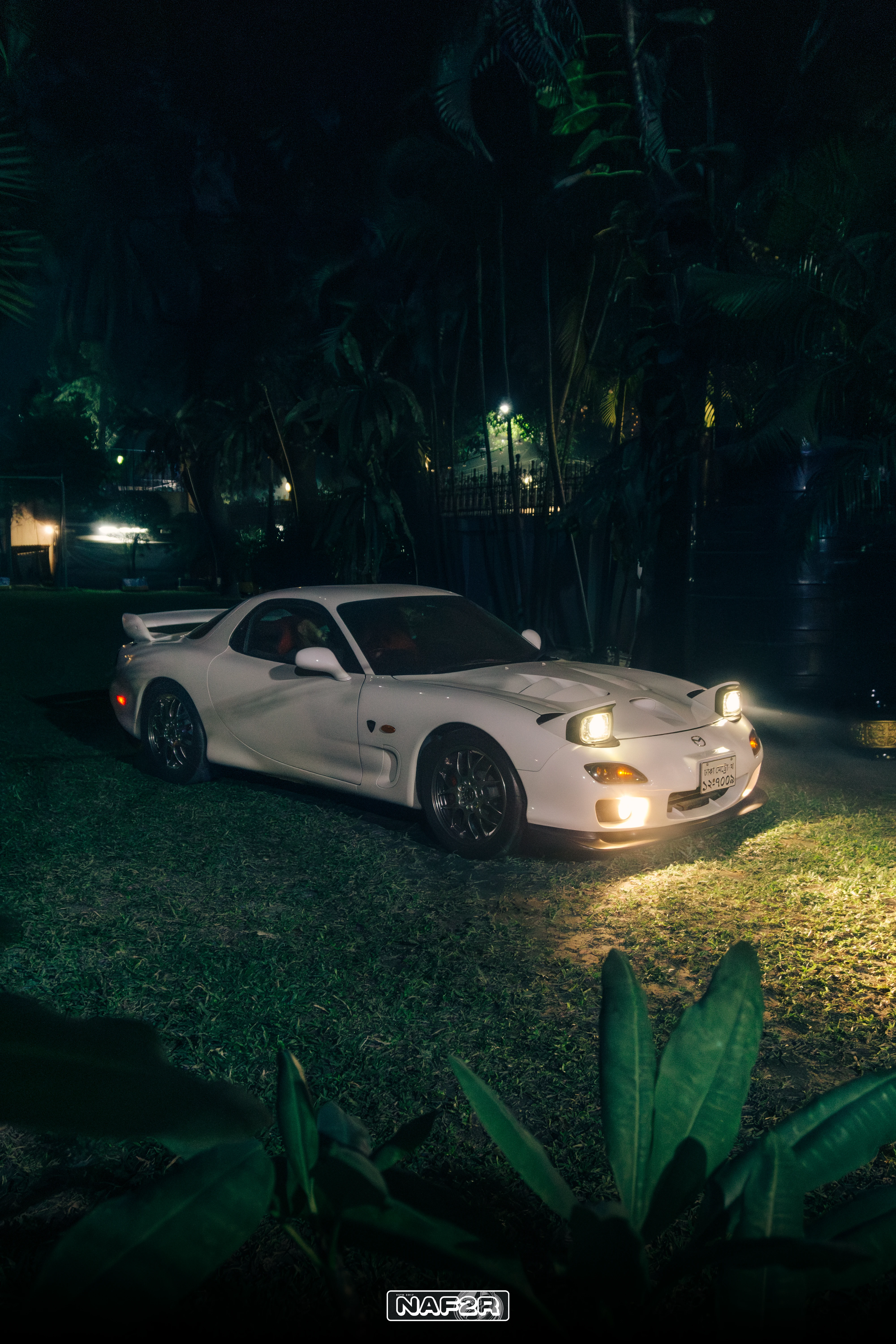 Mazda RX-7 FD3S Spirit R, white, lit at night in a Dhaka garden