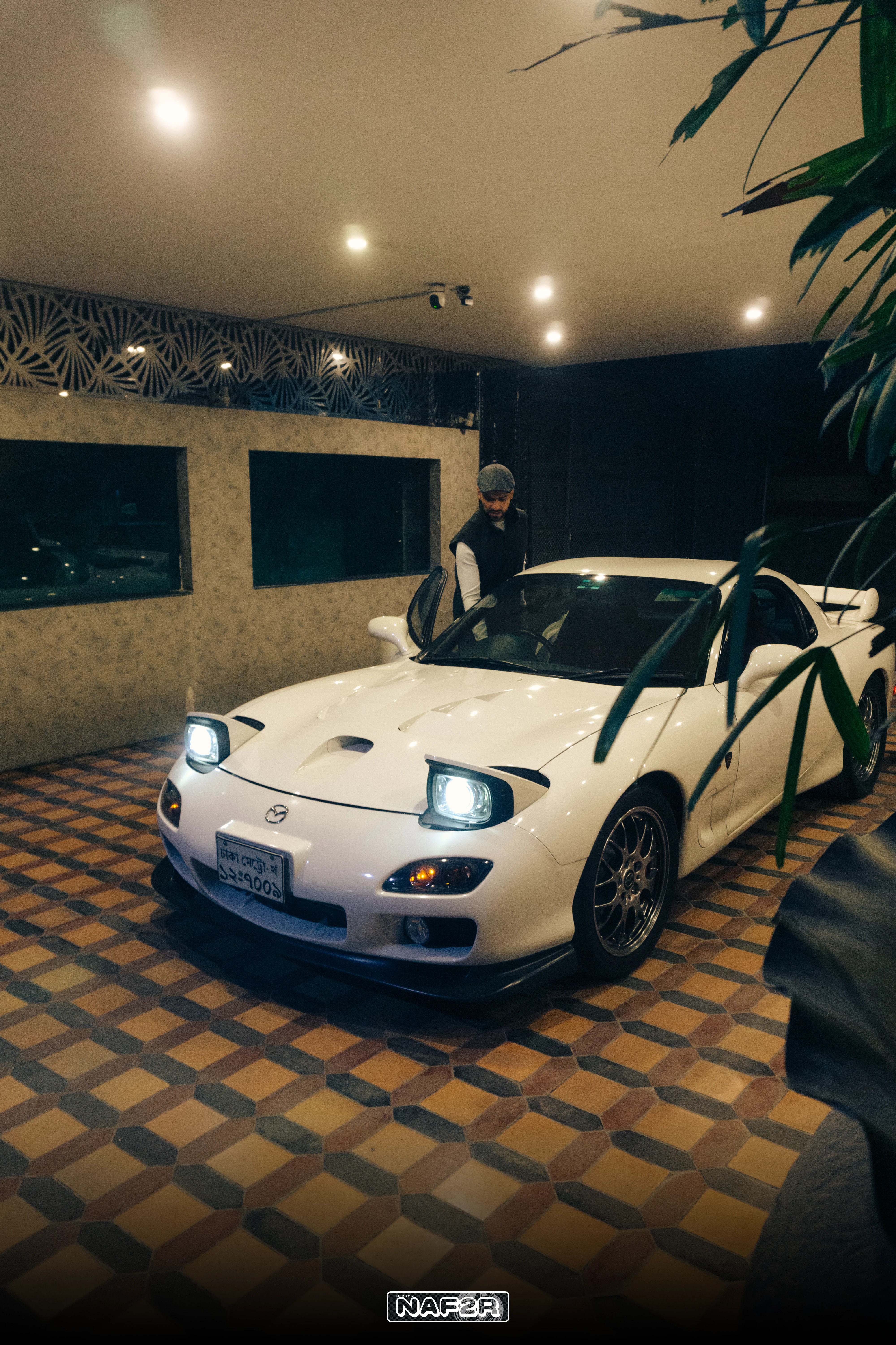 Shezad Javed beside his RX-7 Spirit R in the garage