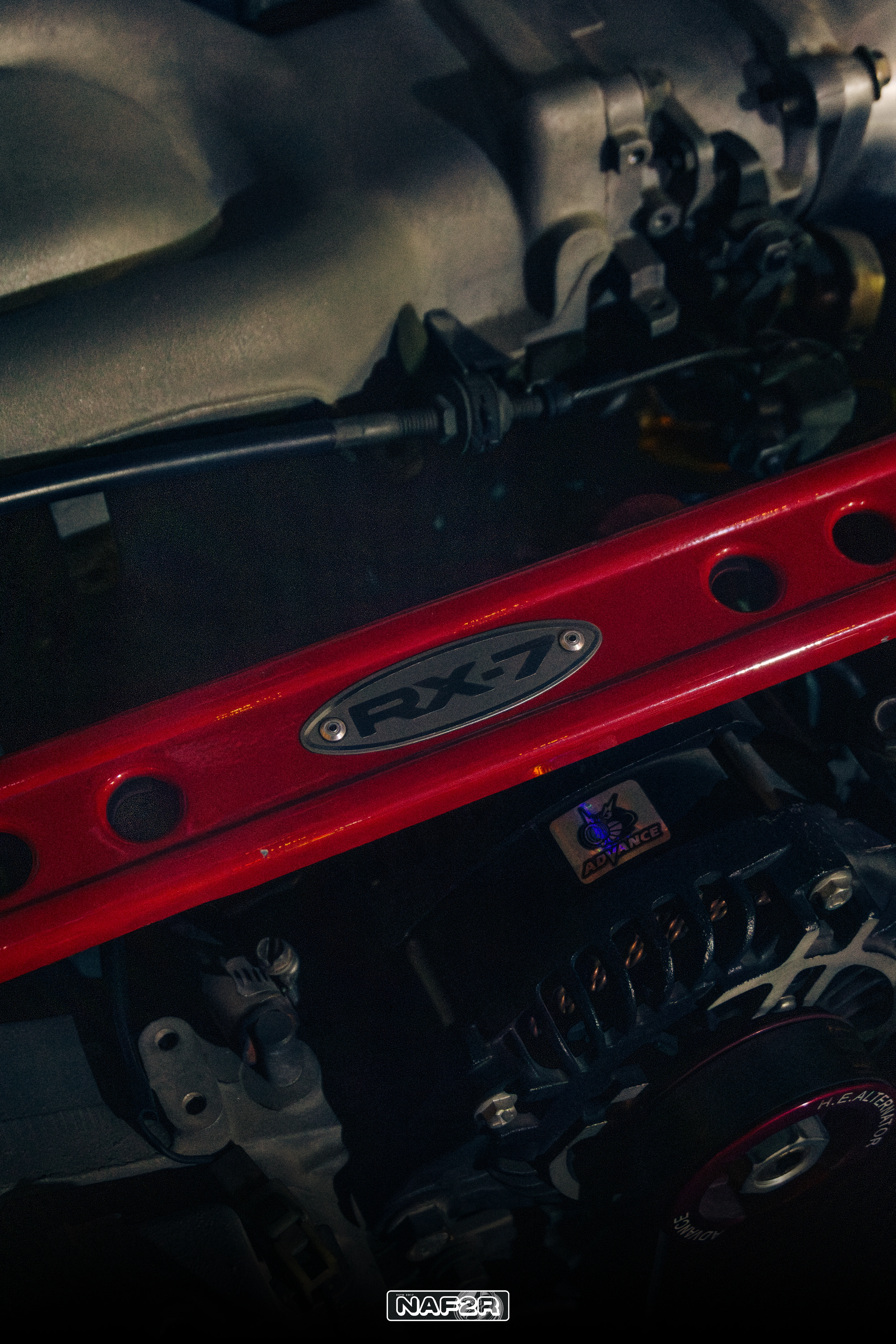 Engine bay with red RX-7 strut brace